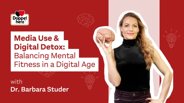 Titre de l'image : Un événement sur l'utilisation des médias et la détox numérique. Une femme, Dr. Barbara Studer, souriante, tient un modèle de cerveau dans sa main, vêtue d'un haut noir. En arrière-plan, des éléments graphiques évoquent le bien-être mental et la technologie.